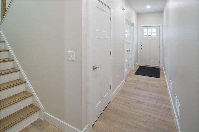 doorway to outside with stairs, baseboards, visible vents, and light wood-style floors