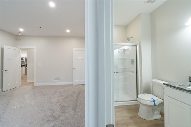 full bath with a stall shower, recessed lighting, visible vents, and vanity