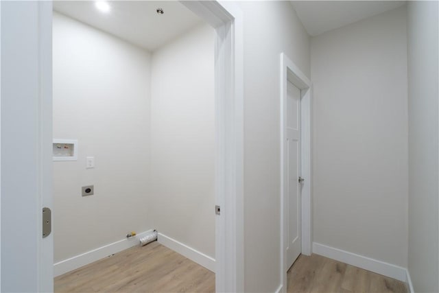 clothes washing area featuring hookup for a washing machine, hookup for a gas dryer, hookup for an electric dryer, light wood-type flooring, and baseboards