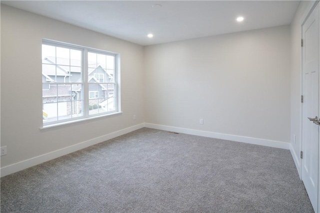 carpeted spare room with recessed lighting and baseboards