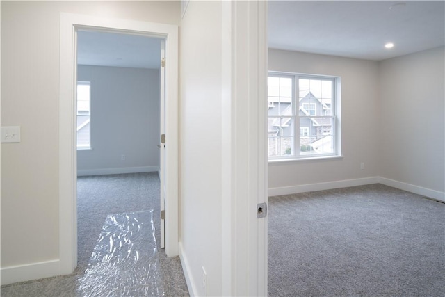 corridor featuring carpet, baseboards, and recessed lighting