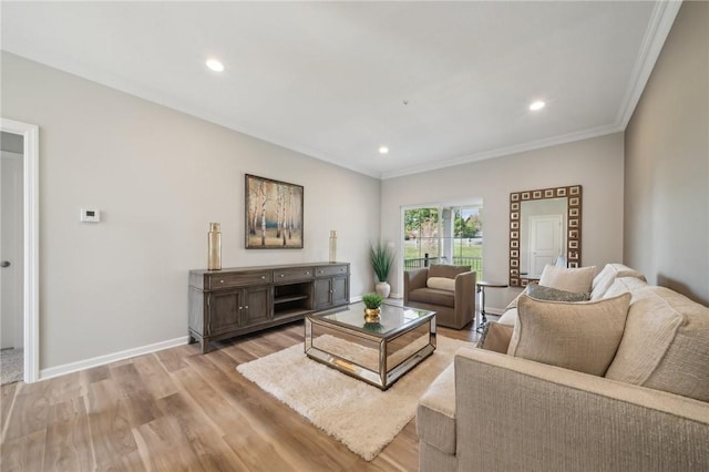 living room with light wood-type flooring and ornamental molding