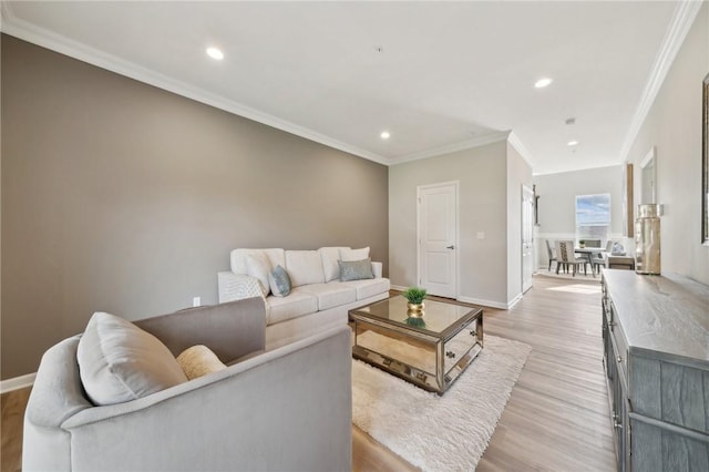 living room with light wood-type flooring and crown molding