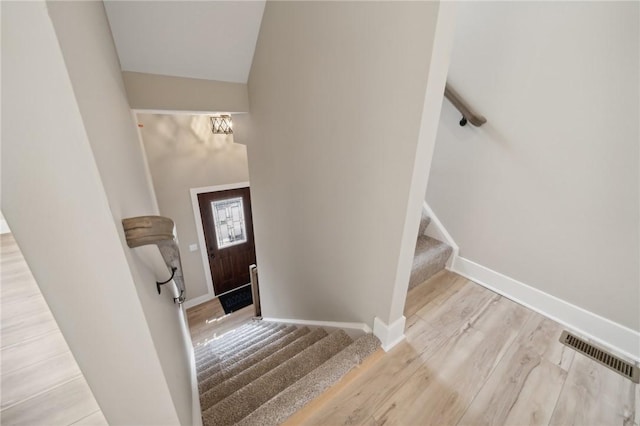 staircase with hardwood / wood-style floors