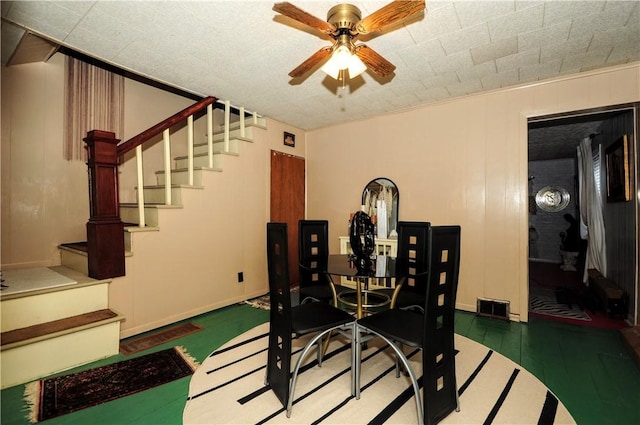 dining space with ceiling fan and crown molding