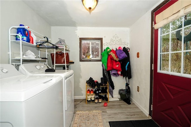 laundry room with washer and clothes dryer and light hardwood / wood-style floors