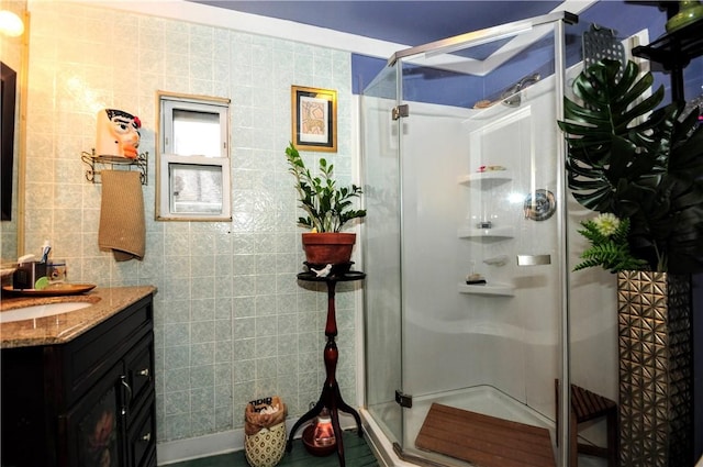 bathroom featuring vanity, tile walls, and walk in shower