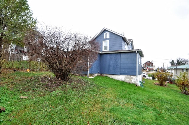 rear view of property with a lawn