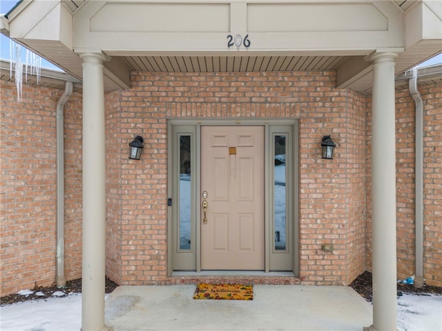 view of snow covered property entrance