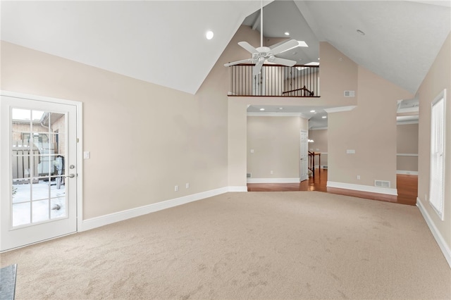 unfurnished living room featuring ceiling fan, carpet floors, and high vaulted ceiling