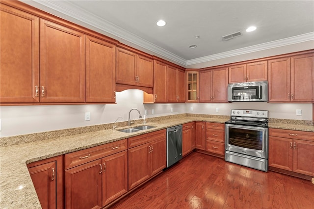 kitchen featuring crown molding, light stone counters, sink, and appliances with stainless steel finishes