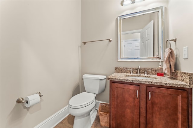 bathroom with tile patterned flooring, vanity, and toilet