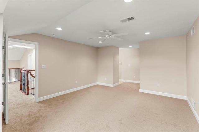 empty room featuring light colored carpet, ceiling fan, and lofted ceiling