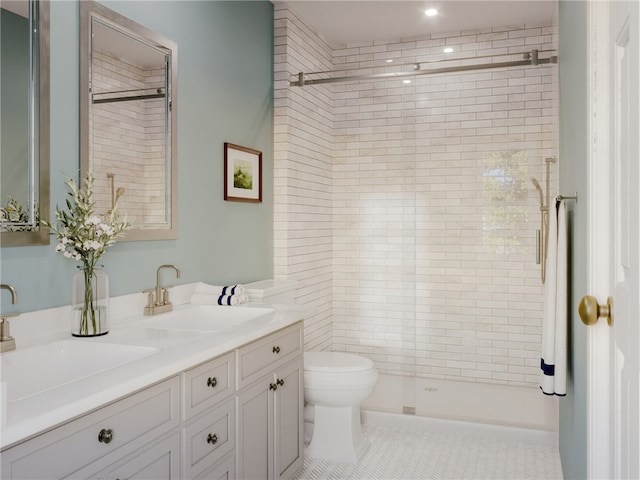 bathroom featuring tile patterned floors, vanity, an enclosed shower, and toilet