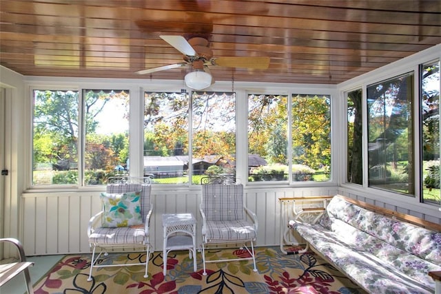 unfurnished sunroom featuring ceiling fan and wood ceiling