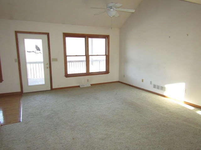 carpeted empty room with vaulted ceiling and ceiling fan