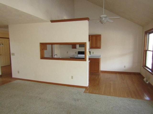 unfurnished living room with ceiling fan and lofted ceiling