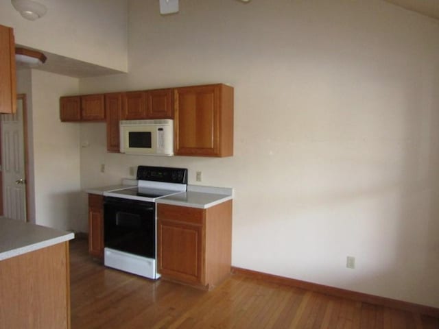 kitchen featuring light wood-type flooring and white appliances