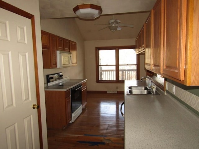 kitchen with lofted ceiling, ceiling fan, sink, and white appliances