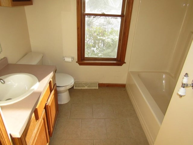 bathroom featuring tile patterned floors, vanity, and toilet