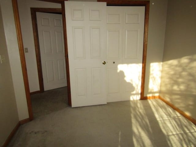 unfurnished bedroom with carpet floors and a closet