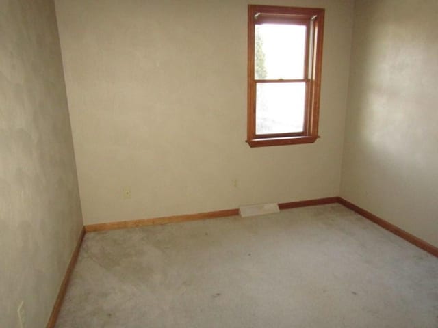 empty room with light colored carpet