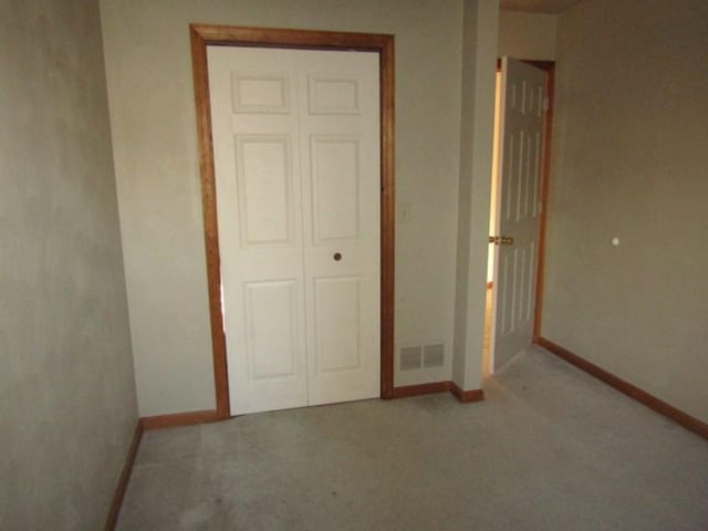 unfurnished bedroom with carpet and a closet