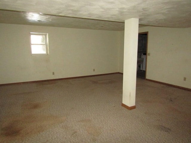 basement with carpet floors and a textured ceiling