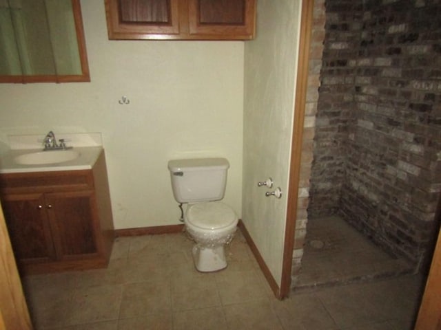 bathroom featuring toilet, vanity, and walk in shower