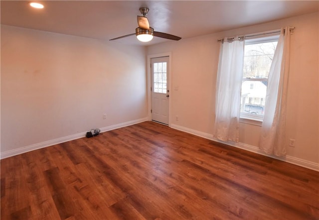 unfurnished room with dark hardwood / wood-style flooring and ceiling fan