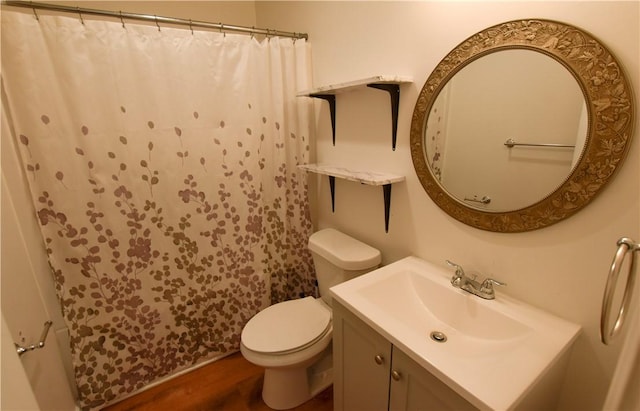 bathroom featuring hardwood / wood-style floors, vanity, toilet, and curtained shower