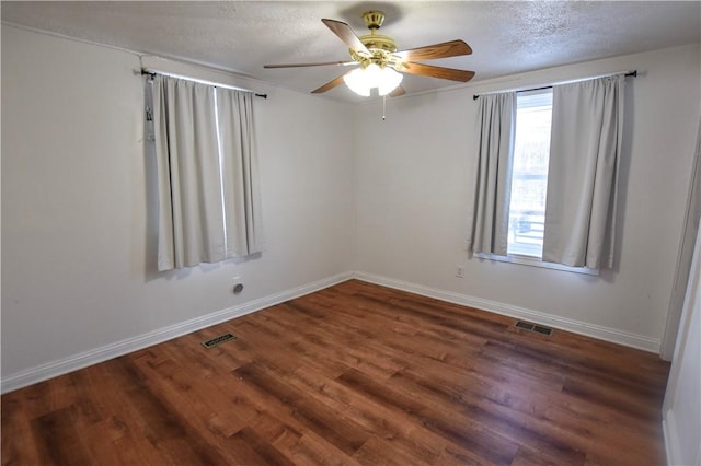 spare room with a textured ceiling, dark hardwood / wood-style flooring, and ceiling fan