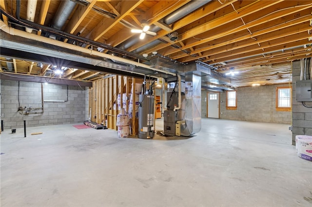 basement with heating unit, electric panel, and water heater