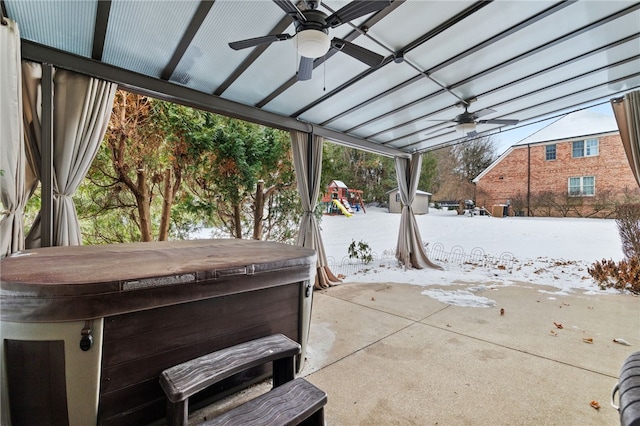 view of patio / terrace with a playground and a hot tub