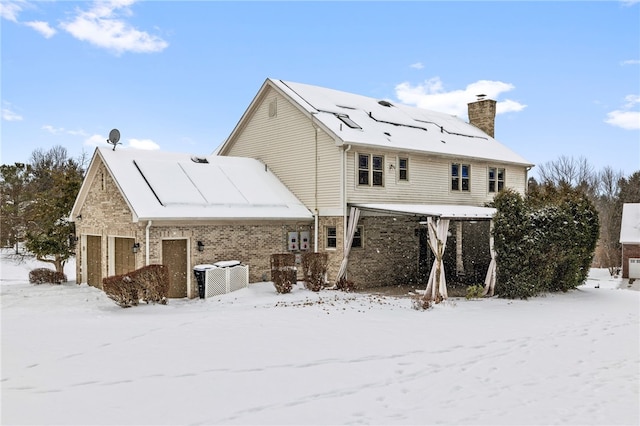 view of snow covered back of property