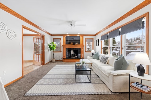 living room with ceiling fan, carpet floors, and crown molding