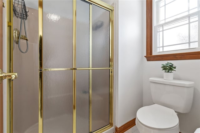 bathroom featuring toilet and a shower with door