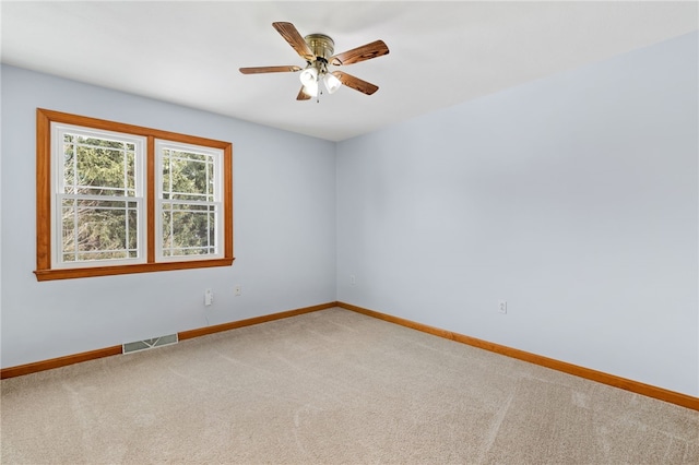 empty room featuring carpet flooring and ceiling fan