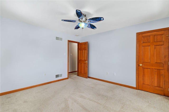 carpeted spare room with ceiling fan