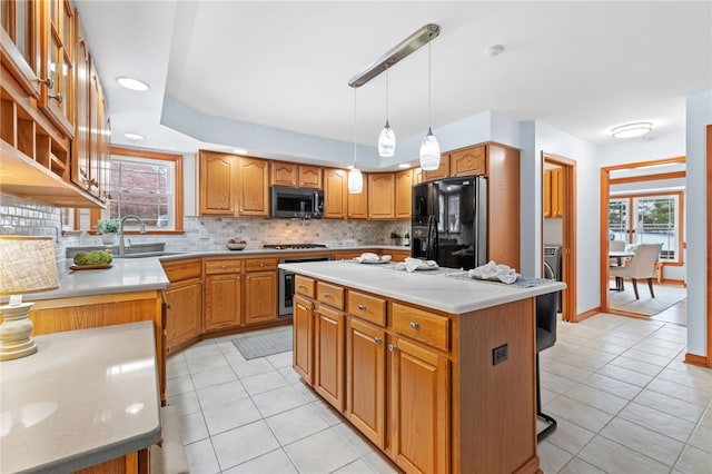 kitchen featuring sink, light tile patterned floors, pendant lighting, black fridge with ice dispenser, and a kitchen island