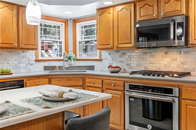 kitchen with backsplash, stainless steel appliances, and sink