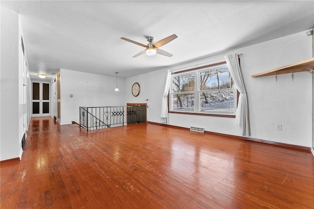 unfurnished living room featuring hardwood / wood-style floors and ceiling fan