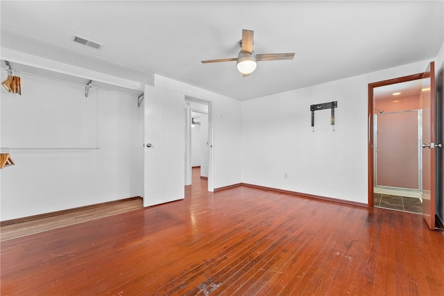 empty room with ceiling fan and wood-type flooring