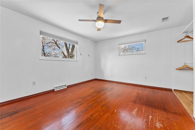 empty room featuring ceiling fan and hardwood / wood-style floors