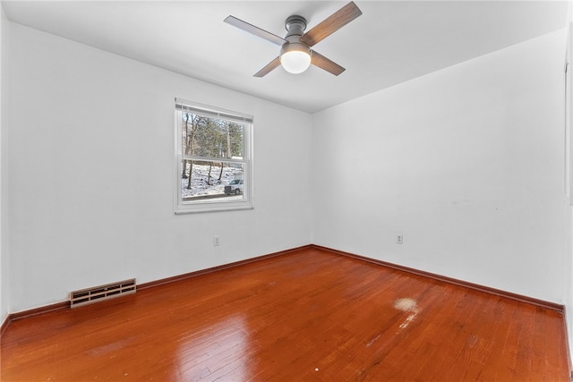 empty room featuring ceiling fan and hardwood / wood-style floors