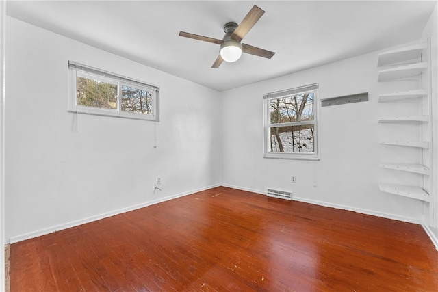 empty room featuring hardwood / wood-style flooring and ceiling fan