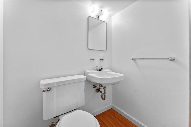 bathroom featuring hardwood / wood-style flooring and toilet