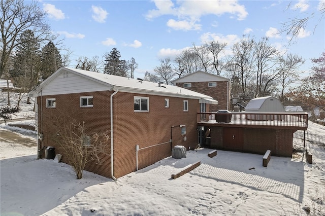 snow covered house featuring a deck