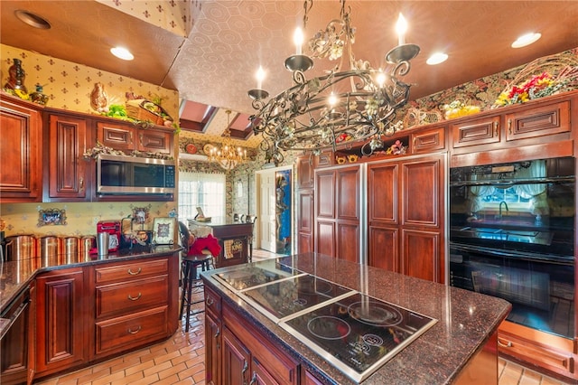 kitchen with black appliances, decorative light fixtures, dark stone counters, and a chandelier