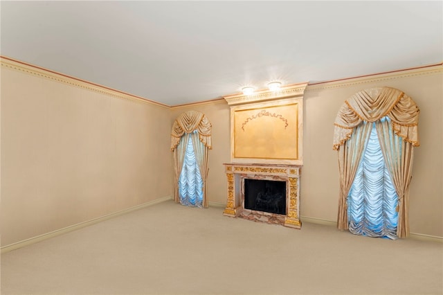 unfurnished living room featuring carpet, crown molding, and a high end fireplace